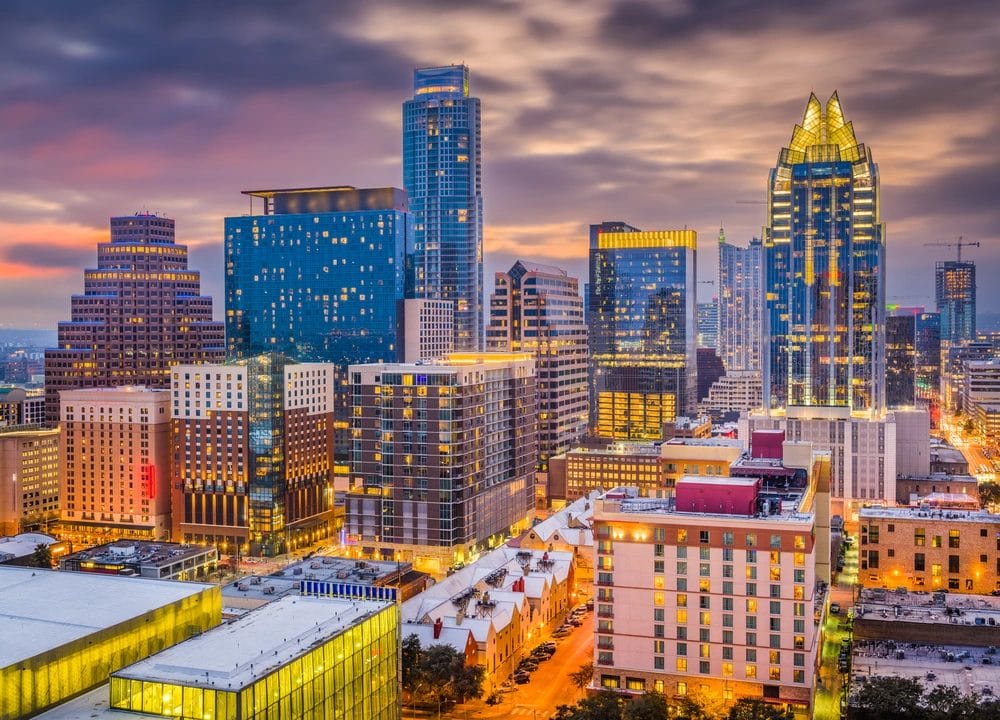 Austin, Texas skyline aglow with a vibrant sunset, highlighting its unique architecture